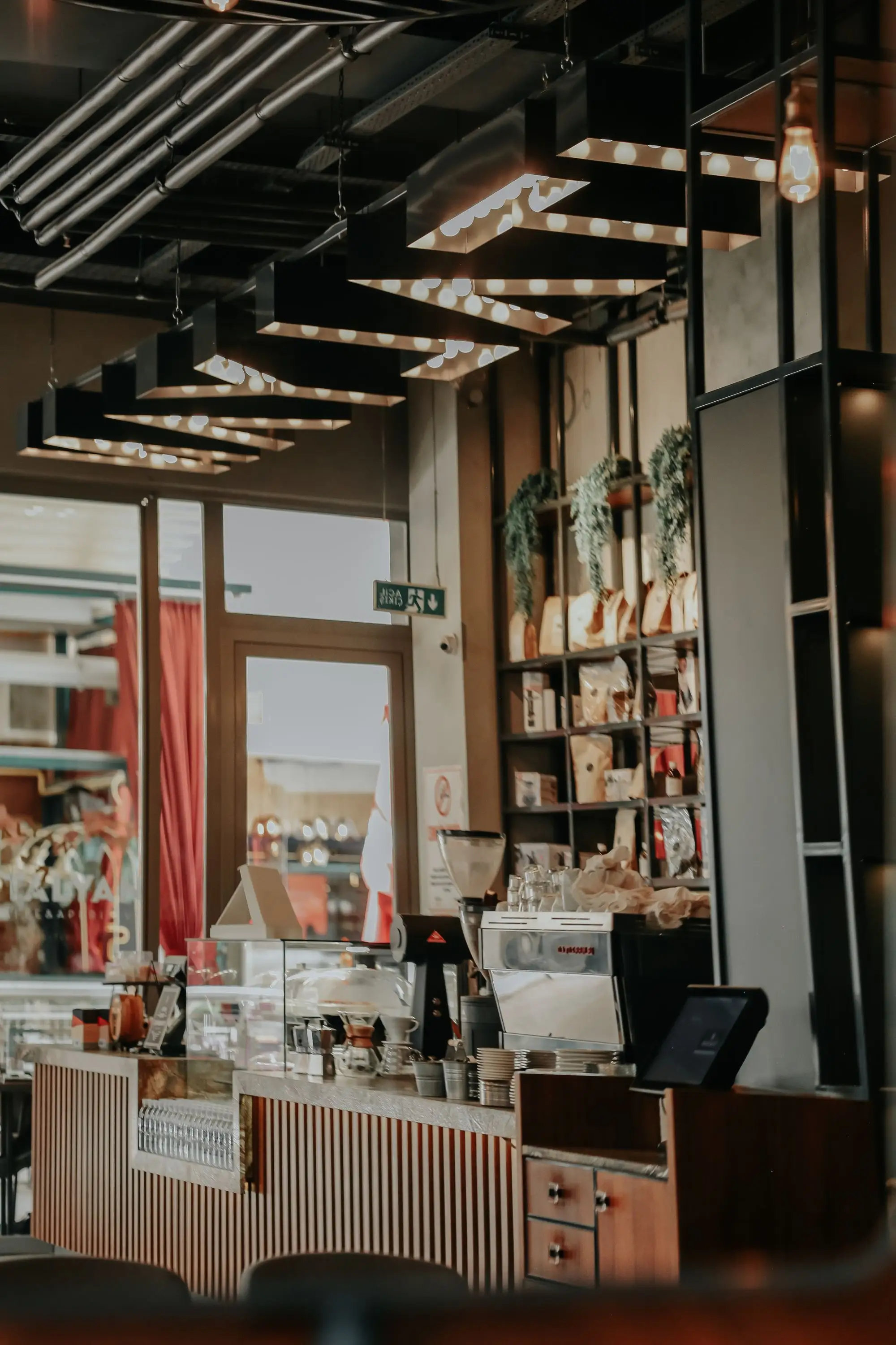 Warm wood coffeehouse counter with pendant lighting