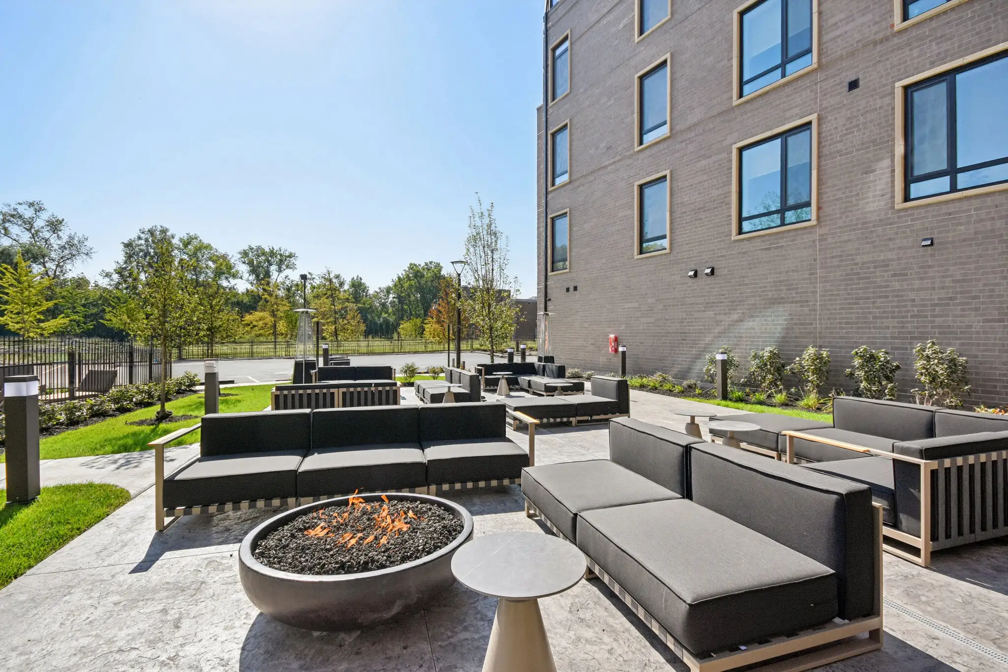 Courtyard lounge with outdoor sofas around a fire pit