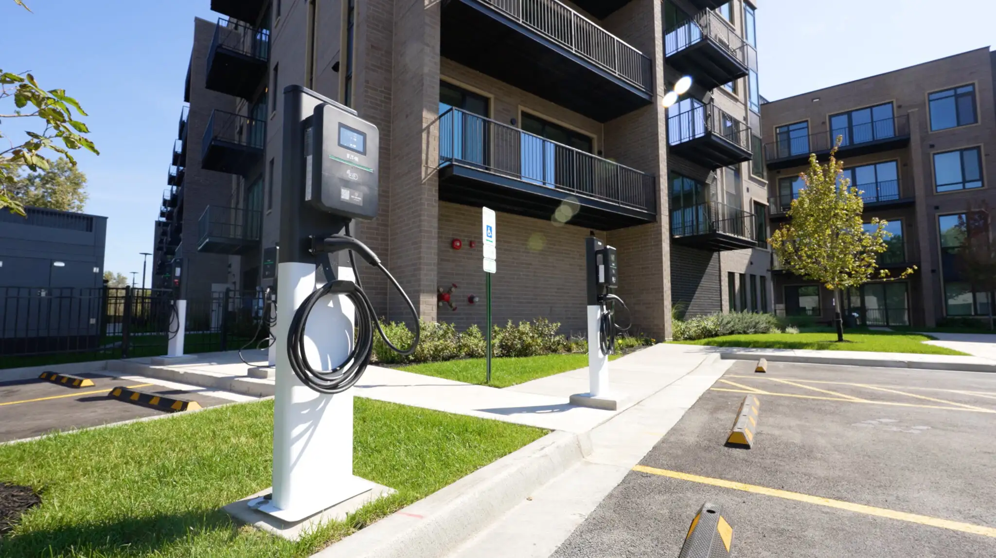 Electric vehicle chargers beside parking spaces