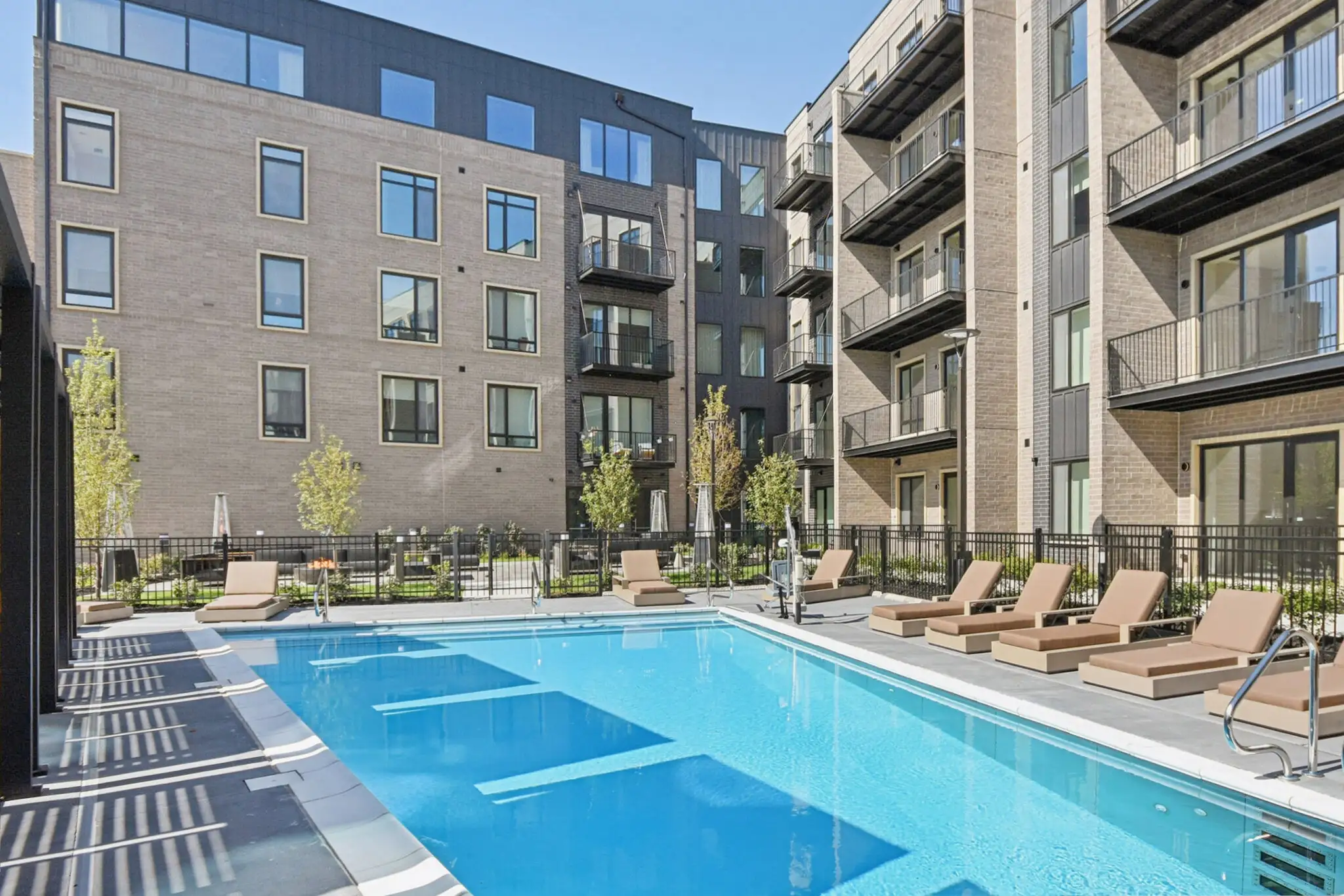 Outdoor pool with lounge chairs along the deck