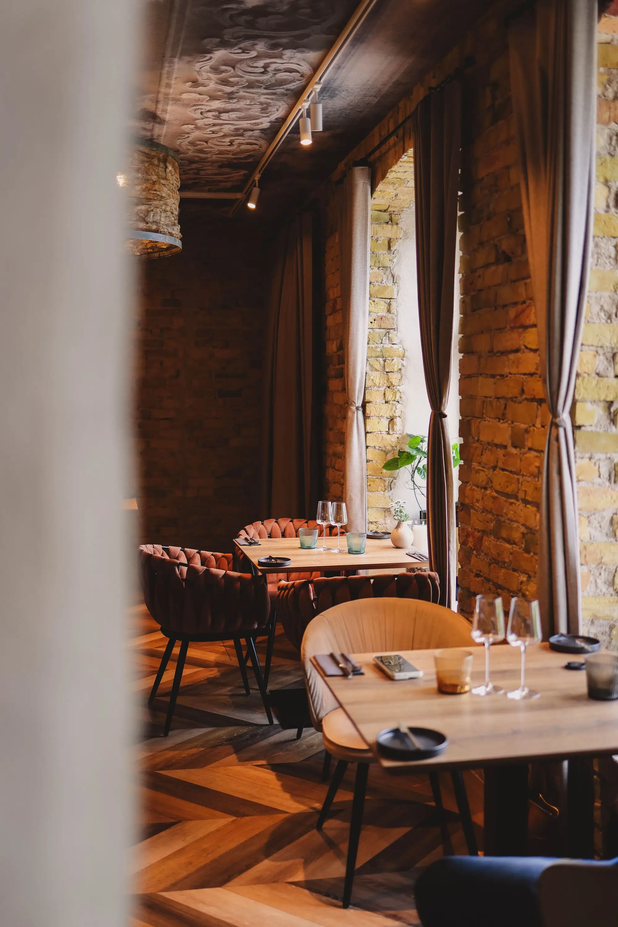 Sunlit restaurant dining room with wood tables and chairs