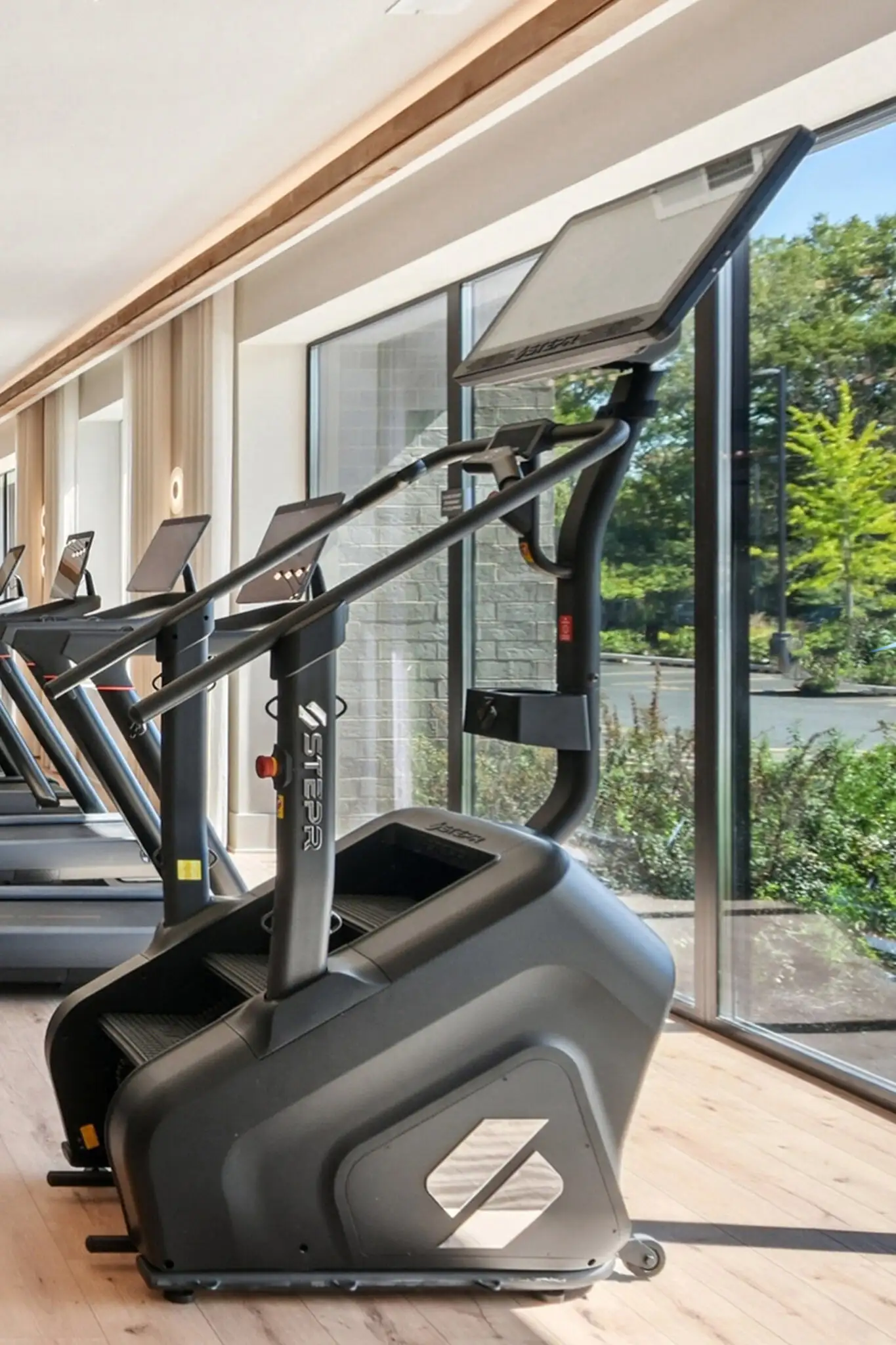Stepr stair climber beside floor-to-ceiling windows